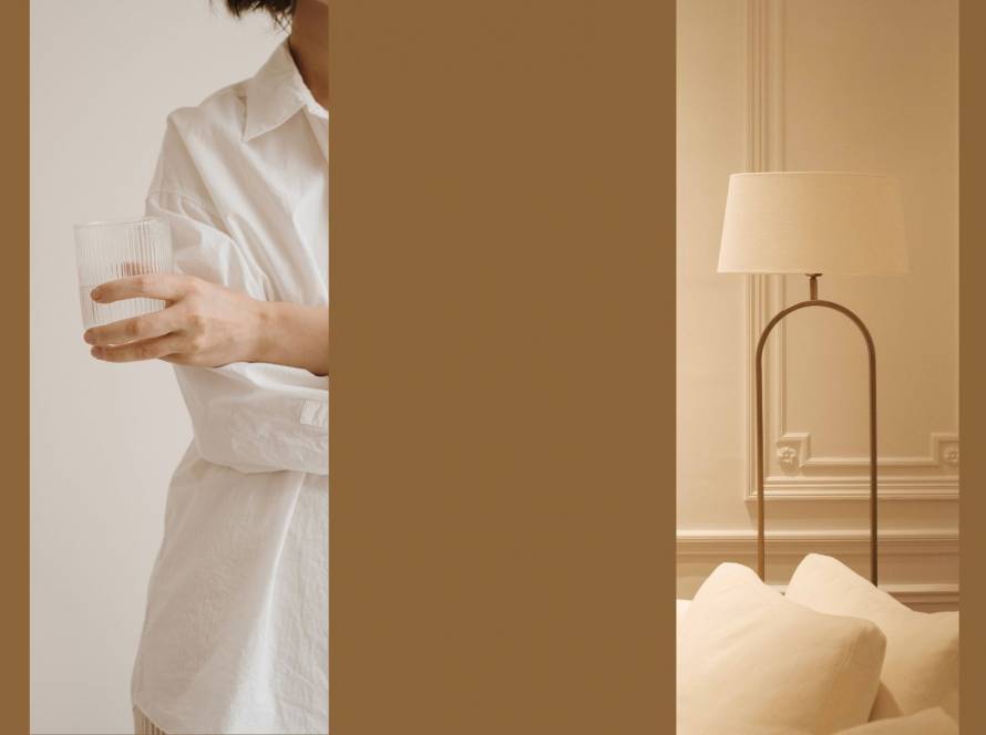 A woman holding a glass alongside a warm interior with a brass lamp — exploring the body as home, by Karen Toms therapist and counsellor