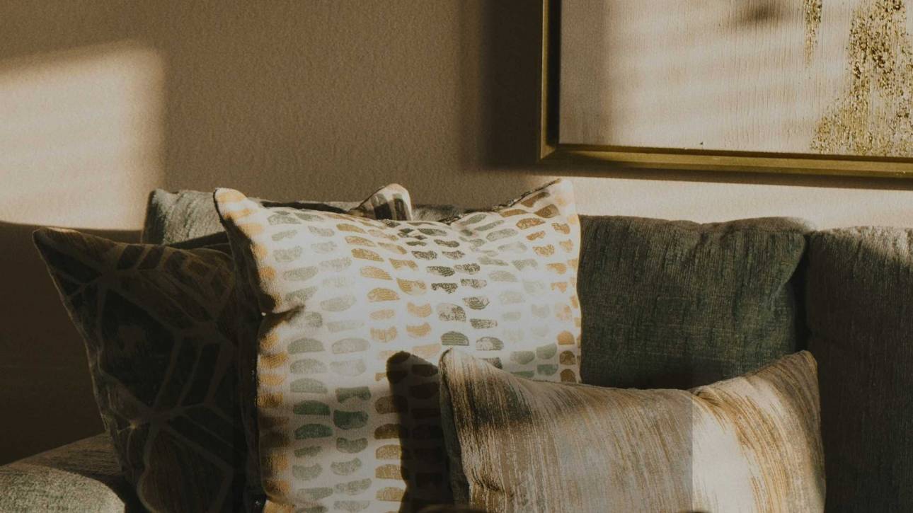 A warm domestic interior with an empty sofa in soft light, illustrating a post about the absence of praise and self-worth