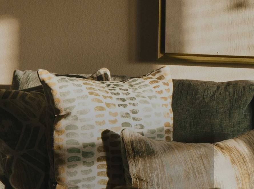 A warm domestic interior with an empty sofa in soft light, illustrating a post about the absence of praise and self-worth