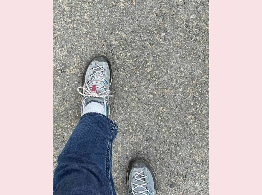 Looking down at feet mid-stride on a tarmac path, an ordinary everyday walk